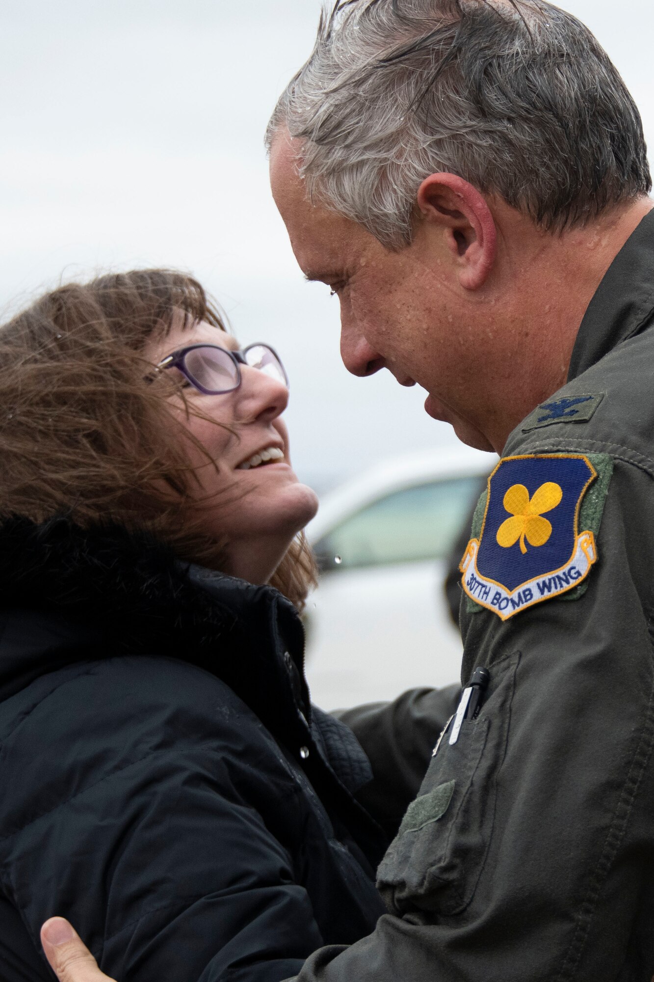 Col. Burgess and his wife hug on the flight line.