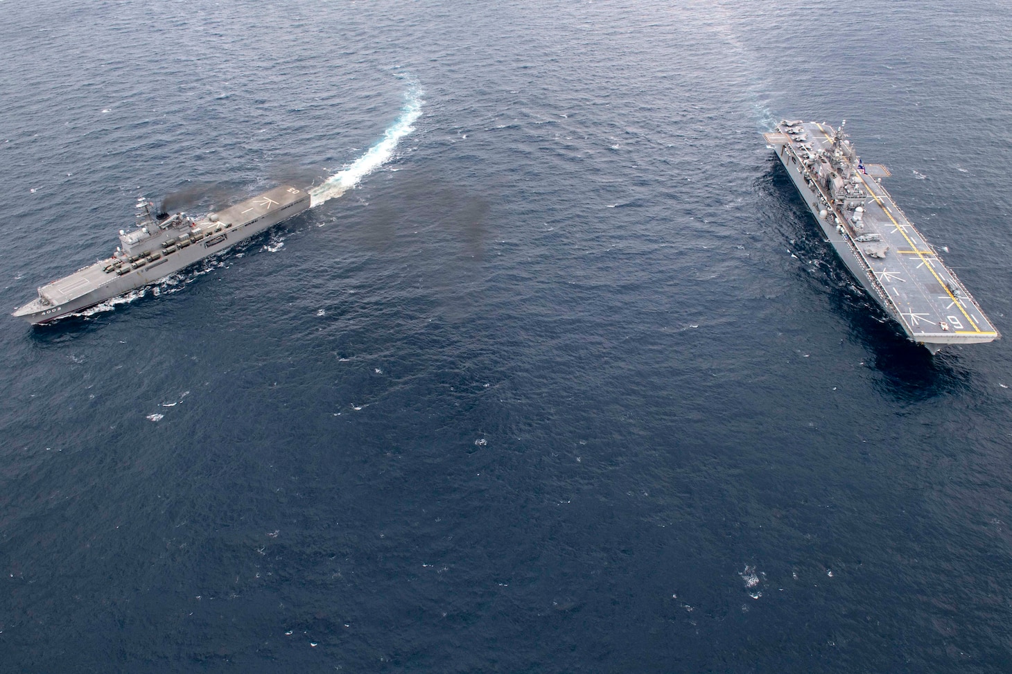 EAST CHINA SEA (Jan. 13, 2020) Amphibious assault ship USS America (LHA 6) and Japan Maritime Self-Defense Force amphibious transport dock ship JS Kunisaki (LST 4003) operate together in the East China Sea. The America Expeditionary Strike Group, 31st Marine Expeditionary Unit team is operating in the U.S. 7th Fleet area of operations to enhance interoperability with allies and partners and serve as a ready response force to defend peace and stability in the Indo-Pacific region.