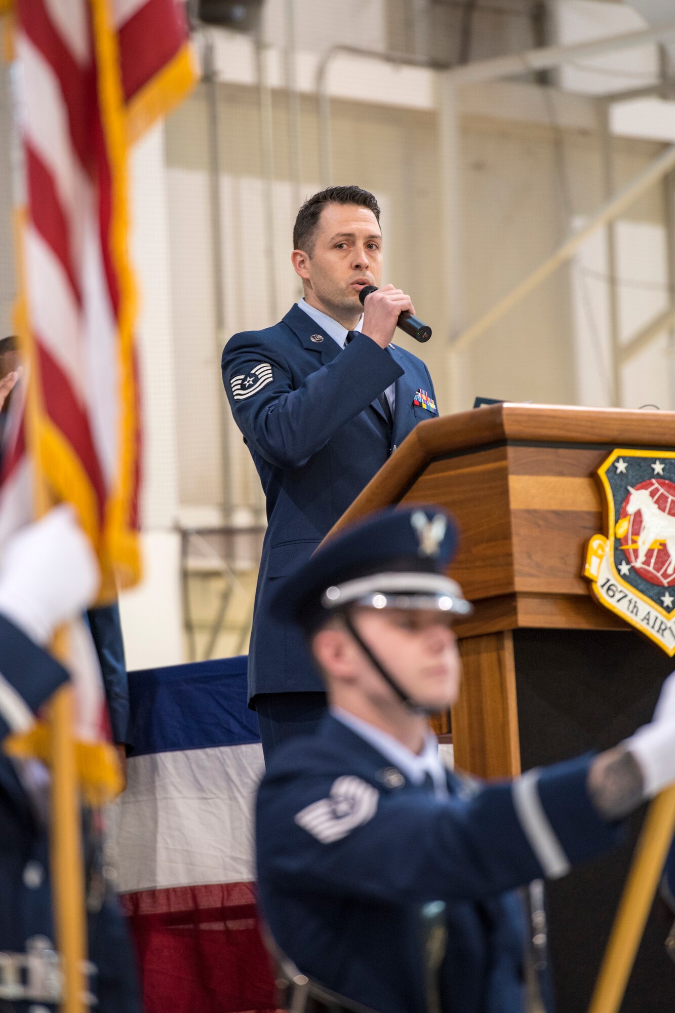 Tech. Sgt. Joshua Robins sings the national anthem flag at the start of a change of command ceremony, Jan. 12, 2020. Col. Martin Timko assumed command of the wing and Col. David Cochran relinquished command during the ceremony.
