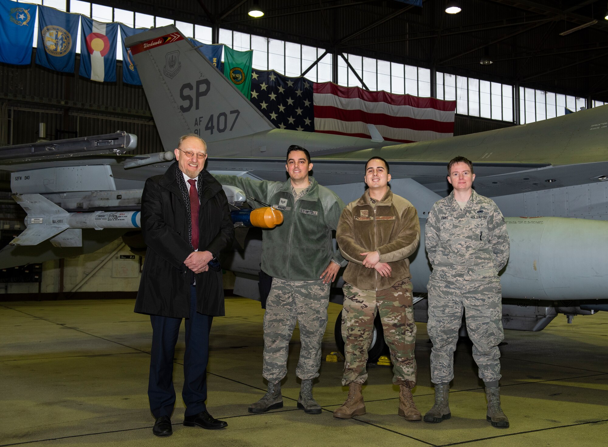 Dr. Heinrich Kreft, German ambassador to Luxembourg, far left, poses for a photo with 52nd Maintenance Squadron Airmen in front of an F-16 Fighting Falcon at Spangdahlem Air Base, Germany, Jan. 13, 2020. Kreft observed the Airmen as they loaded weapons onto the aircraft during a training exercise. (U.S. Air Force photo by Airman 1st Class Alison Stewart)