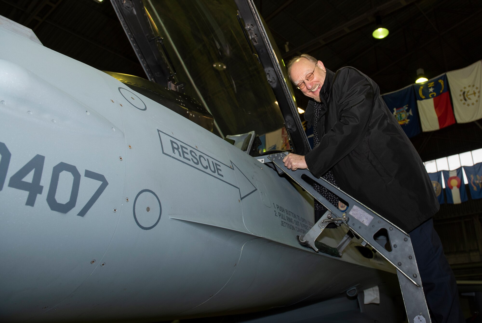 Dr. Heinrich Kreft, German ambassador to Luxembourg, climbs up to the cockpit of an F-16 Fighting Falcon at Spangdahlem Air Base, Germany, Jan. 13, 2020. Kreft was able to view the aircraft as well as other components of the 52nd Maintenance Squadron during his base tour. (U.S. Air Force photo by Airman 1st Class Alison Stewart)