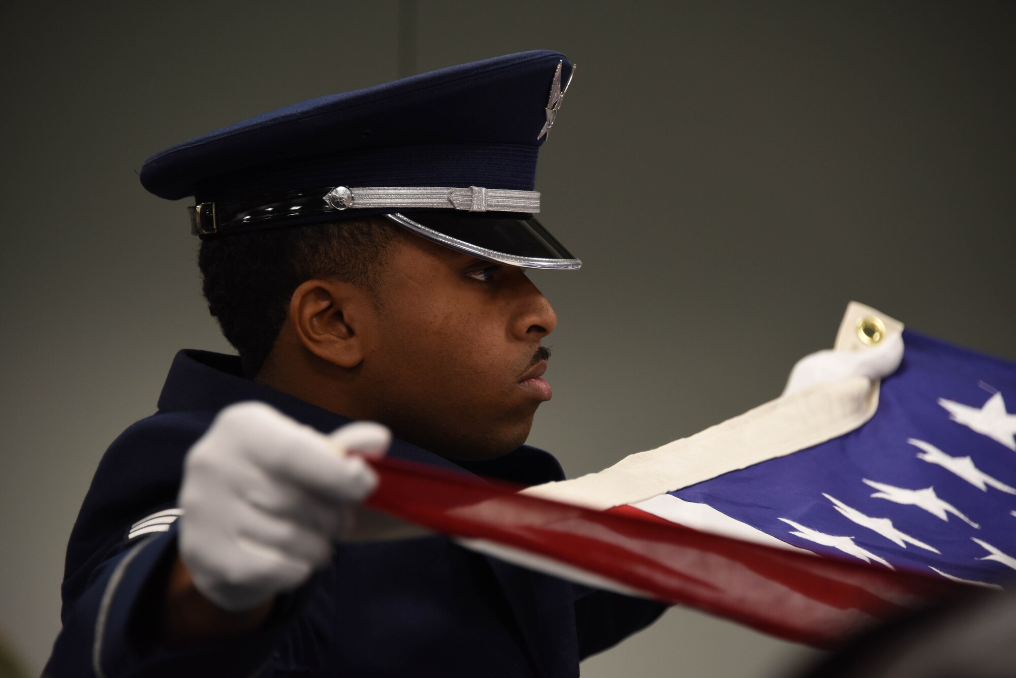 Senior Airman Joseph Dukes III, a ceremonial guardsman assigned to the 911th Airlift Wing, folds the American flag during a base honor guard military funeral demonstration at the Pittsburgh International Airport Air Reserve Station, Pennsylvania, Dec. 8, 2019.