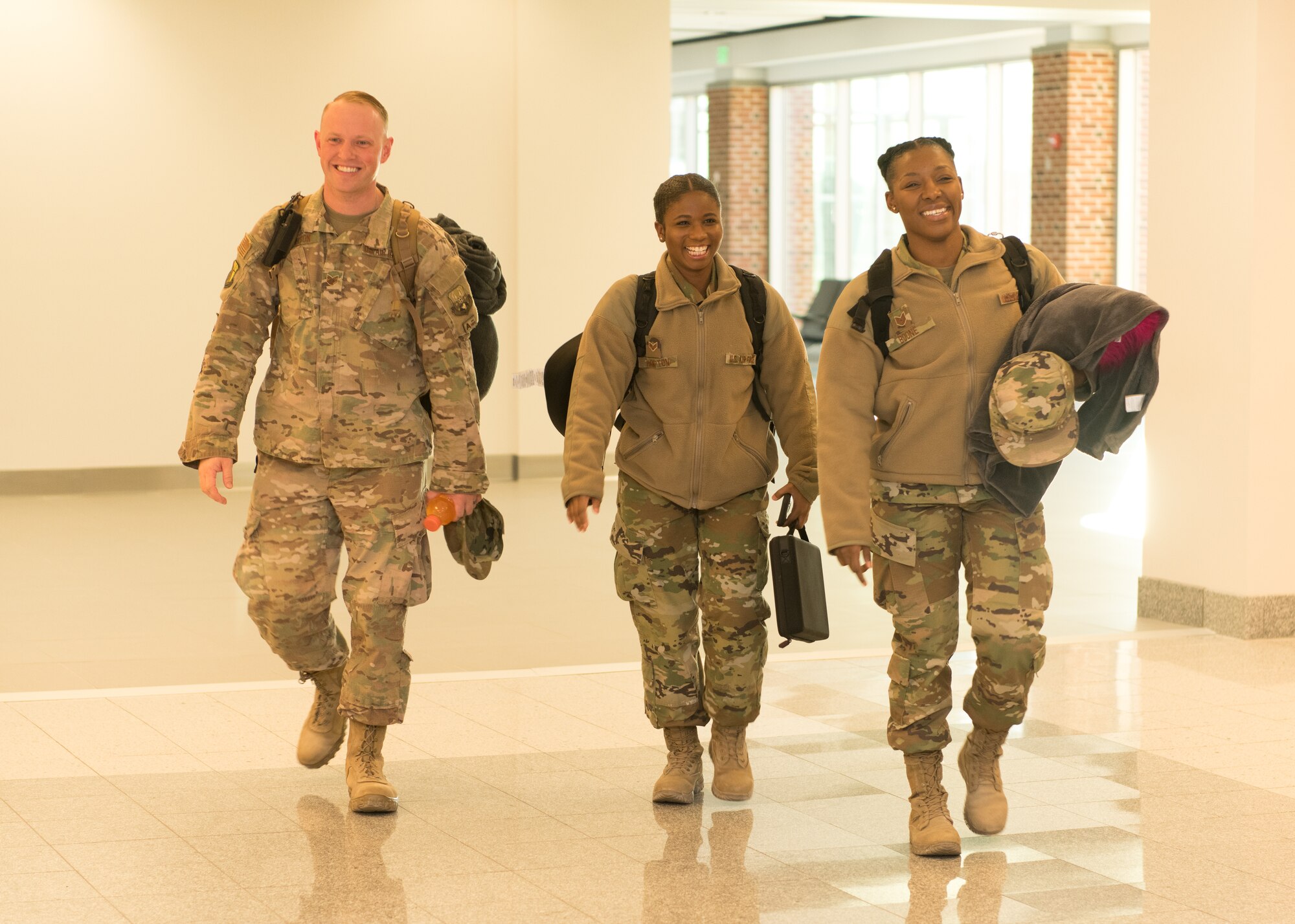 Airmen at an airport return from a deployment