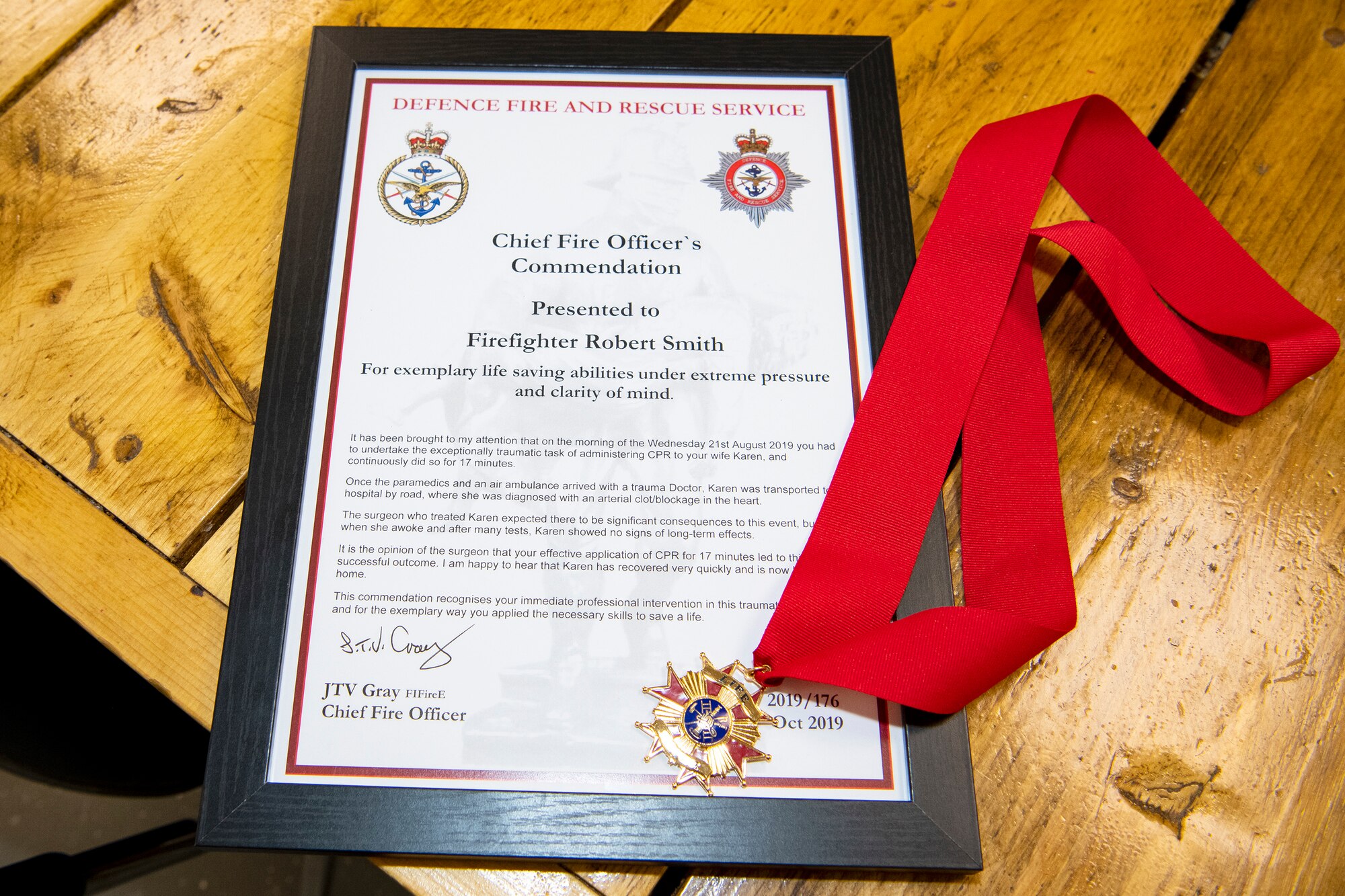 A Chief Fire Officer’s commendation medal rests on a table at RAF Alconbury, Dec. 20, 2019. Robert Smith, 423rd Civil Engineer Squadron firefighter was recognized for exemplary lifesaving abilities under extreme pressure and clarity of mind for actions performed on August 21st. Smith administered CPR to his wife Karen for 17 minutes until paramedics arrived at his home. (U.S. Air Force photo by Senior Airman Eugene Oliver)