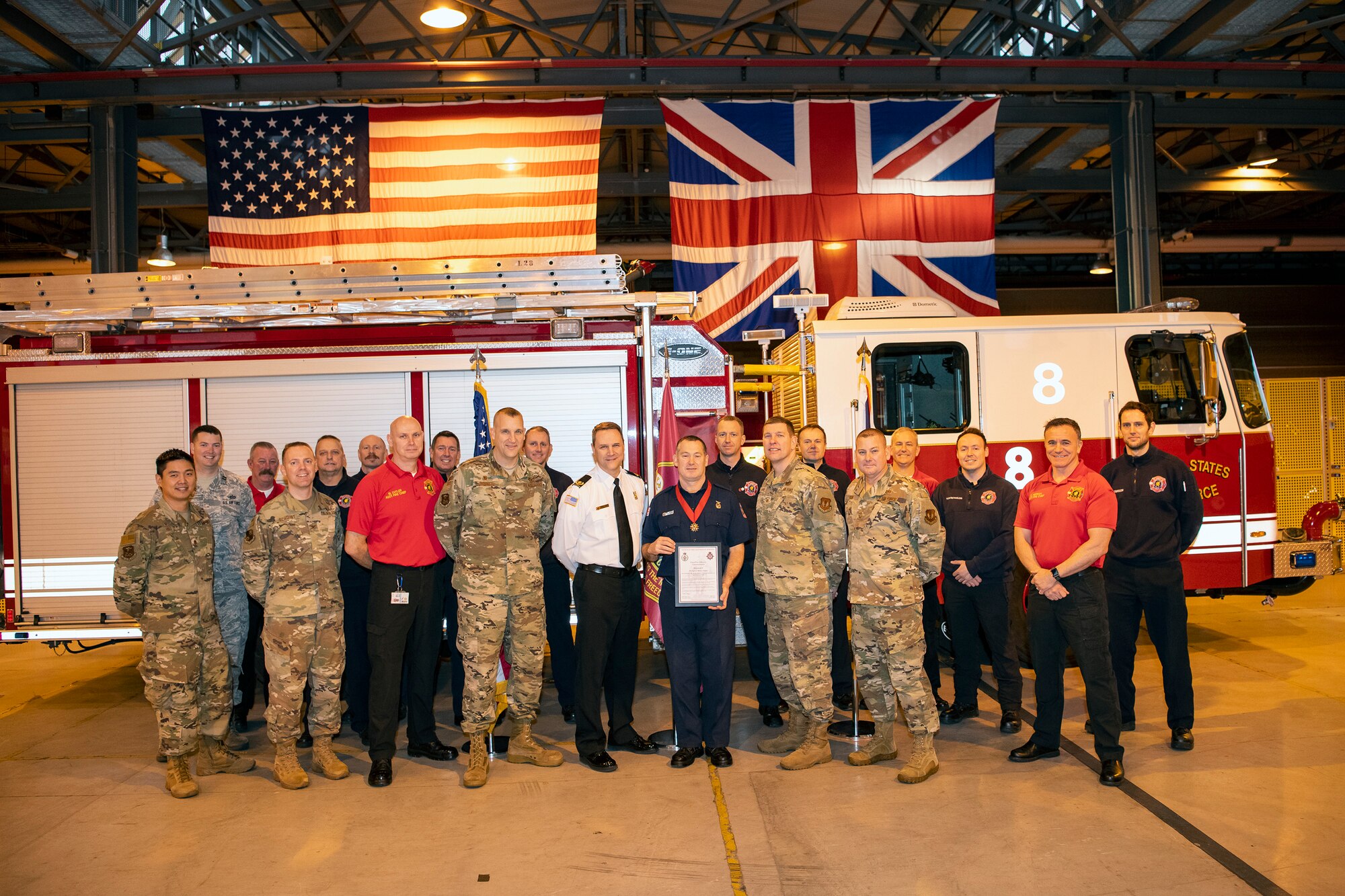 Robert Smith, center, 423rd Civil Engineer Squadron firefighter, poses for a photo along with firefighters and leadership from the 423d CES and 501st Combat Support Wing after receiving a Chief Fire Officer’s commendation medal at RAF Alconbury, Dec. 20, 2019. Smith was recognized for exemplary lifesaving abilities under extreme pressure and clarity of mind for actions performed on August 21st. Smith administered CPR to his wife Karen for 17 minutes until paramedics arrived at his home. (U.S. Air Force photo by Senior Airman Eugene Oliver)