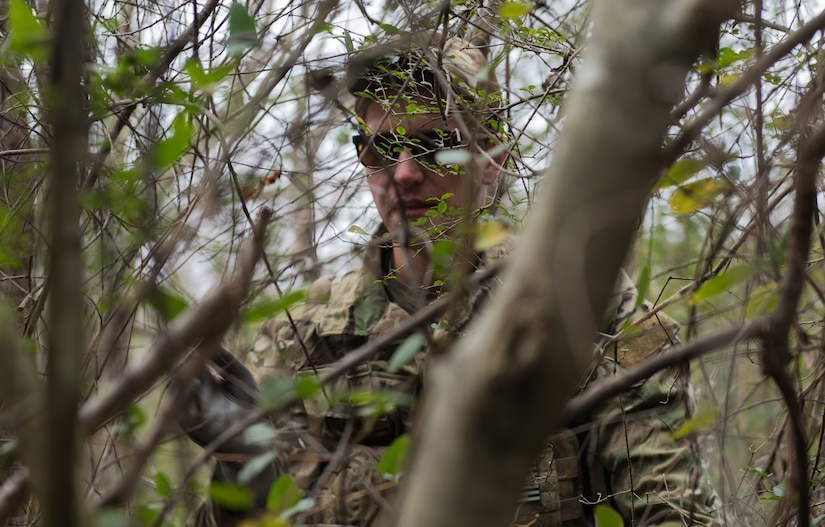 U.S. Air Force Tech. Sgt. Stephen Drakes, 192 Operations Support Squadron, Virginia Air National Guard SERE Survival, Evasion, Resistance and Escape non-commissioned officer in charge, demonstrates camouflaging techniques during a training at Joint Base Langley-Eustis, Virginia, Dec. 12, 2019. The training taught skills needed to survive in a rural or urban area. (U.S. Air Force photo by Airman 1st Class Sarah Dowe)