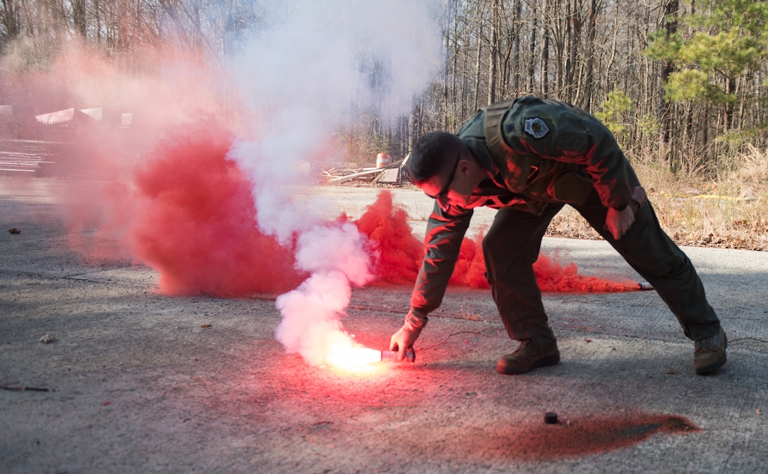 U.S. Air Force Lt. Col. Jonathan Kuntz, 633rd 1st Operations Support Squadron director of operations, places a flare on the ground during a training at Joint Base Langley-Eustis, Virginia, Dec. 12, 2019. The flares are able to be activated in any location in the world during the day or night. (U.S. Air Force photo by Airman 1st Class Sarah Dowe)