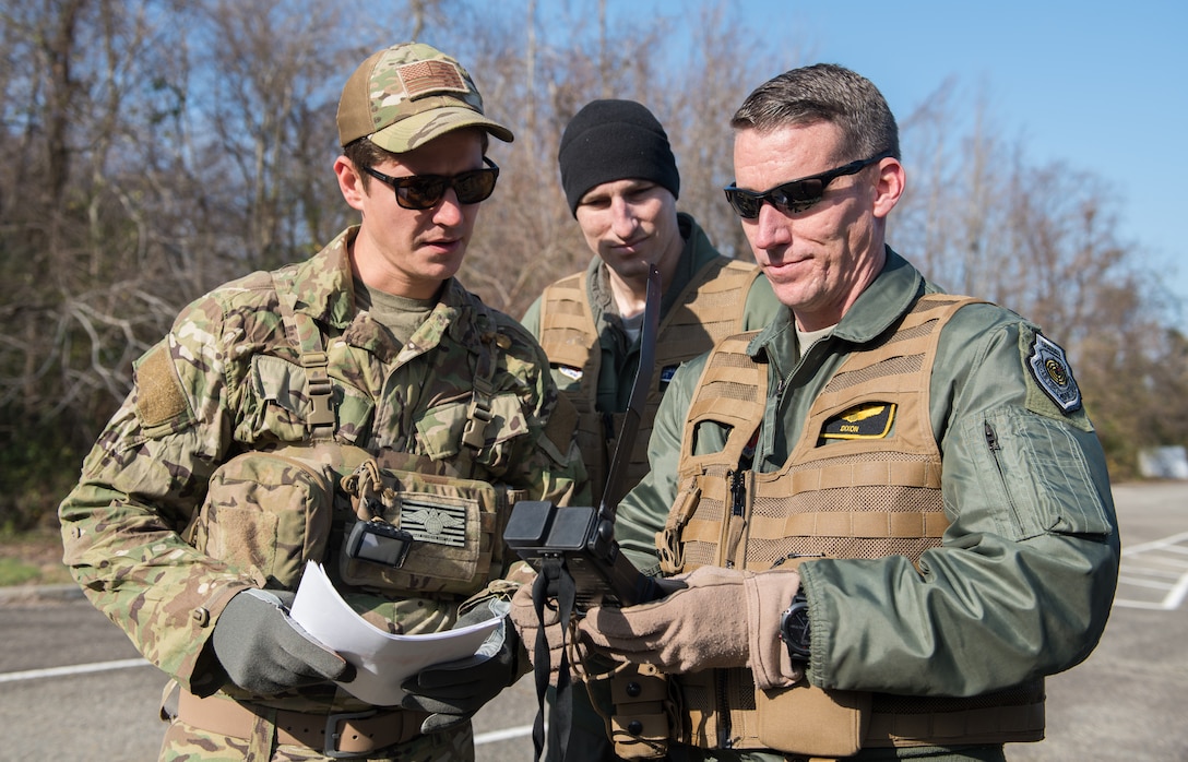 U.S. Air Force Tech. Sgt. Stephen Drakes, 192 Operations Support Squadron, Virginia Air National Guard SERE Survival, Evasion, Resistance and Escape non-commissioned officer in charge, ensures Lt. Col. Jonathan Kuntz, 633rd 1st Operations Support Squadron director of operations, and Capt. Nathan Miller, 94th Fighter Squadron instructor pilot, know how to operate a survival radio during a training at Joint Base Langley-Eustis, Virginia, Dec. 12, 2019. The training taught skills needed to survive in the event of an isolation situation. (U.S. Air Force photo by Airman 1st Class Sarah Dowe)