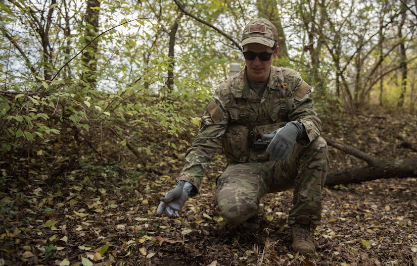 U.S. Air Force Tech. Sgt. Stephen Drakes, 192 Operations Support Squadron, Virginia Air National Guard SERE Survival, Evasion, Resistance and Escape non-commissioned officer in charge, demonstrates camouflaging techniques during a training at Joint Base Langley-Eustis, Virginia, Dec. 12, 2019. Drakes led the training which taught survival skills necessary for an isolation situation. (U.S. Air Force photo by Airman 1st Class Sarah Dowe)