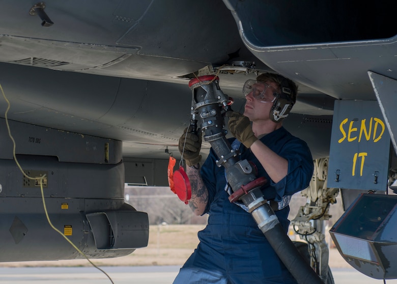 Airman 1st Class Zachary Nottingham, 4th Logistics Readiness Squadron weapons load crew member, executes a hot-pit refueling on an F-15E Strike Eagle.
