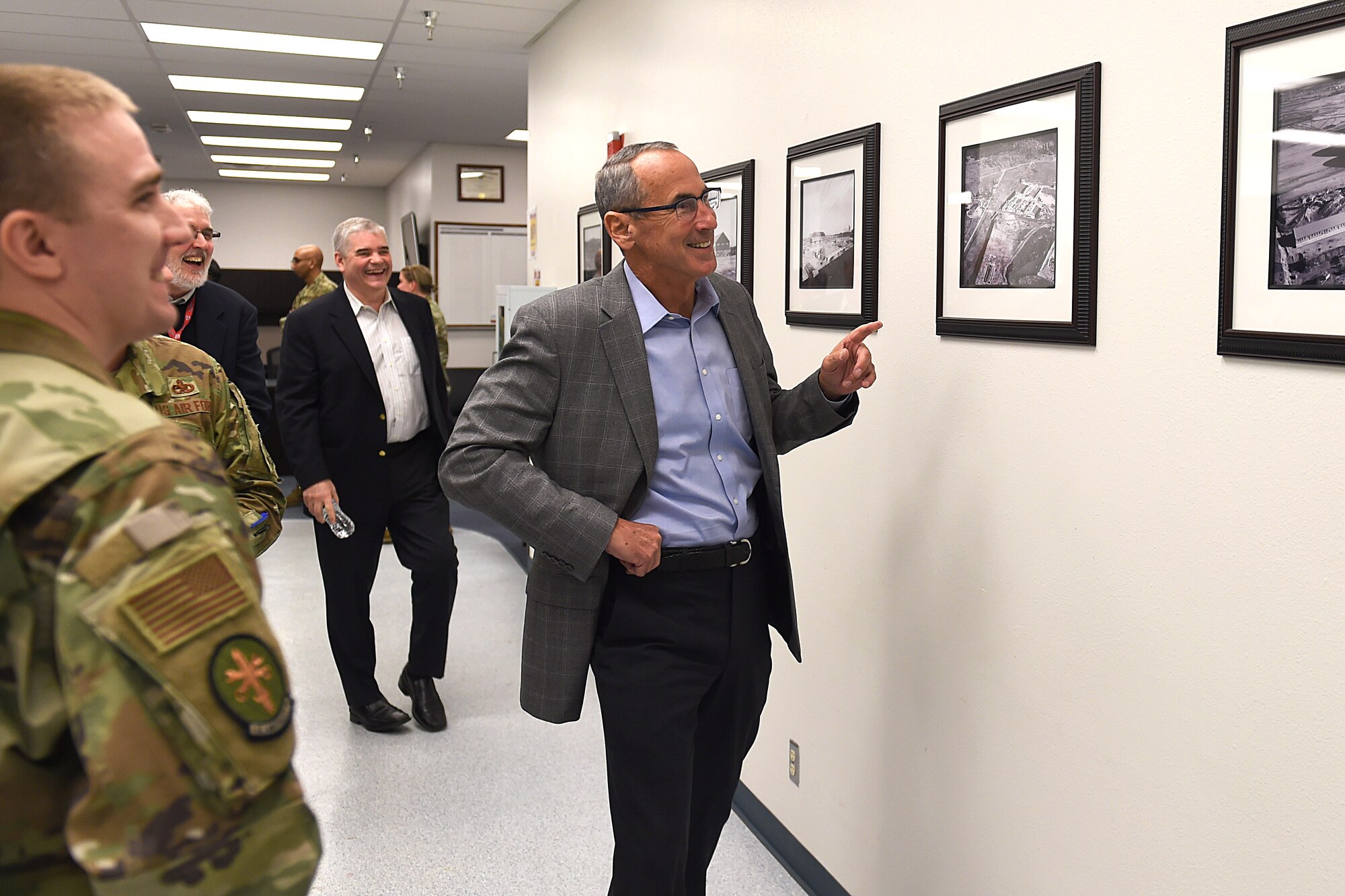 Retired Gen. Raymond Johns, National Commission on Military Aviation Safety (NCMAS) committee member and former 62nd Airlift Wing commander, remembers the photos of when the precision equipment meaurement lap (PMEL) bulding was being built many years ago on Joint Base Lewis-McChord (JBLM), Wash., Jan 7, 2020. Members of the NCMAS visited JBLM to assess the capabilities and obstacles Airmen face in day-to-day operations to maintain McChord’s aircraft capability.