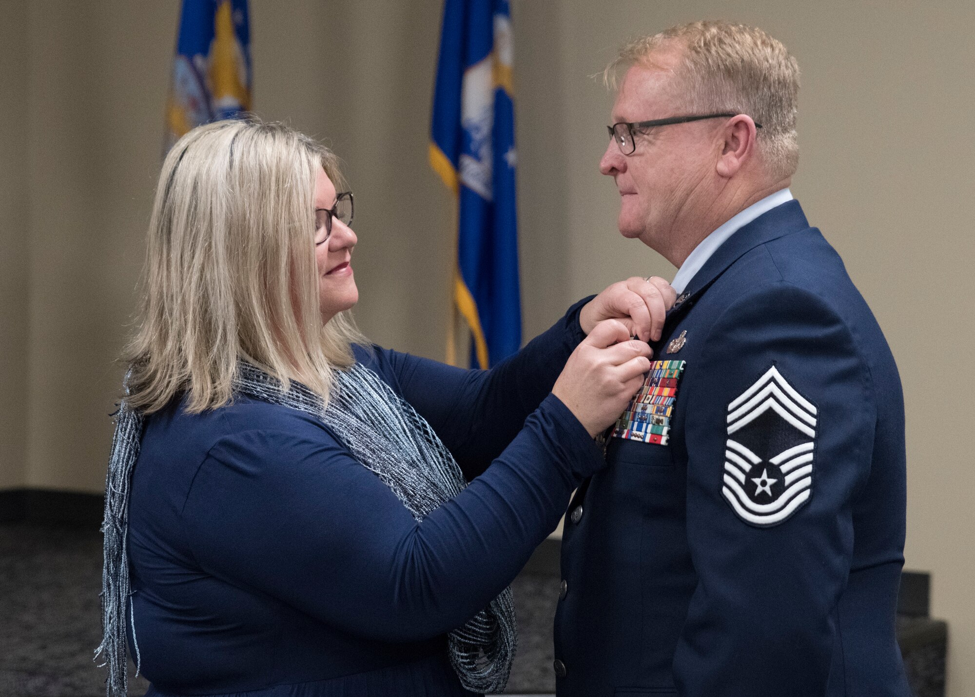 Julie C. Mahan presents Chief Master Sgt. Edgar S. Mahan with his retirement pin during a ceremony at Ebbing Air National Guard Base, Ark., Jan. 11, 2020. Mahan served 30 years in the United States armed forces including the Marines, Army National Guard, and Air National Guard. (U.S. Air National Guard photo by Tech. Sgt. Daniel Condit)