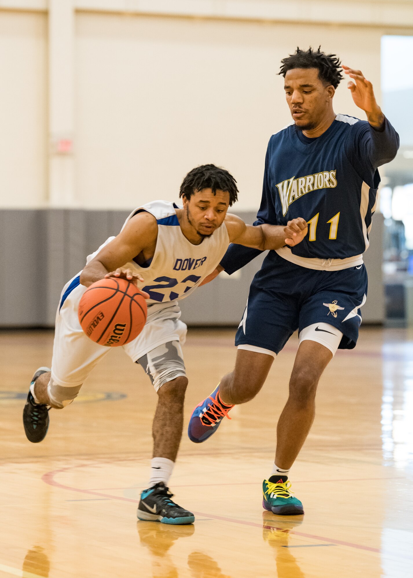 Dover Air Force Base Eagles guard Keondre Robinson (23) dribbles past Naval Support Activity Bethesda Warriors guard William Gilmore Jan. 12, 2020, at the Fitness Center on Dover AFB, Del. The Warriors topped the Eagles, 88-70, in a Washington Area Military Athletic Conference basketball game. (U.S. Air Force photo by Roland Balik)