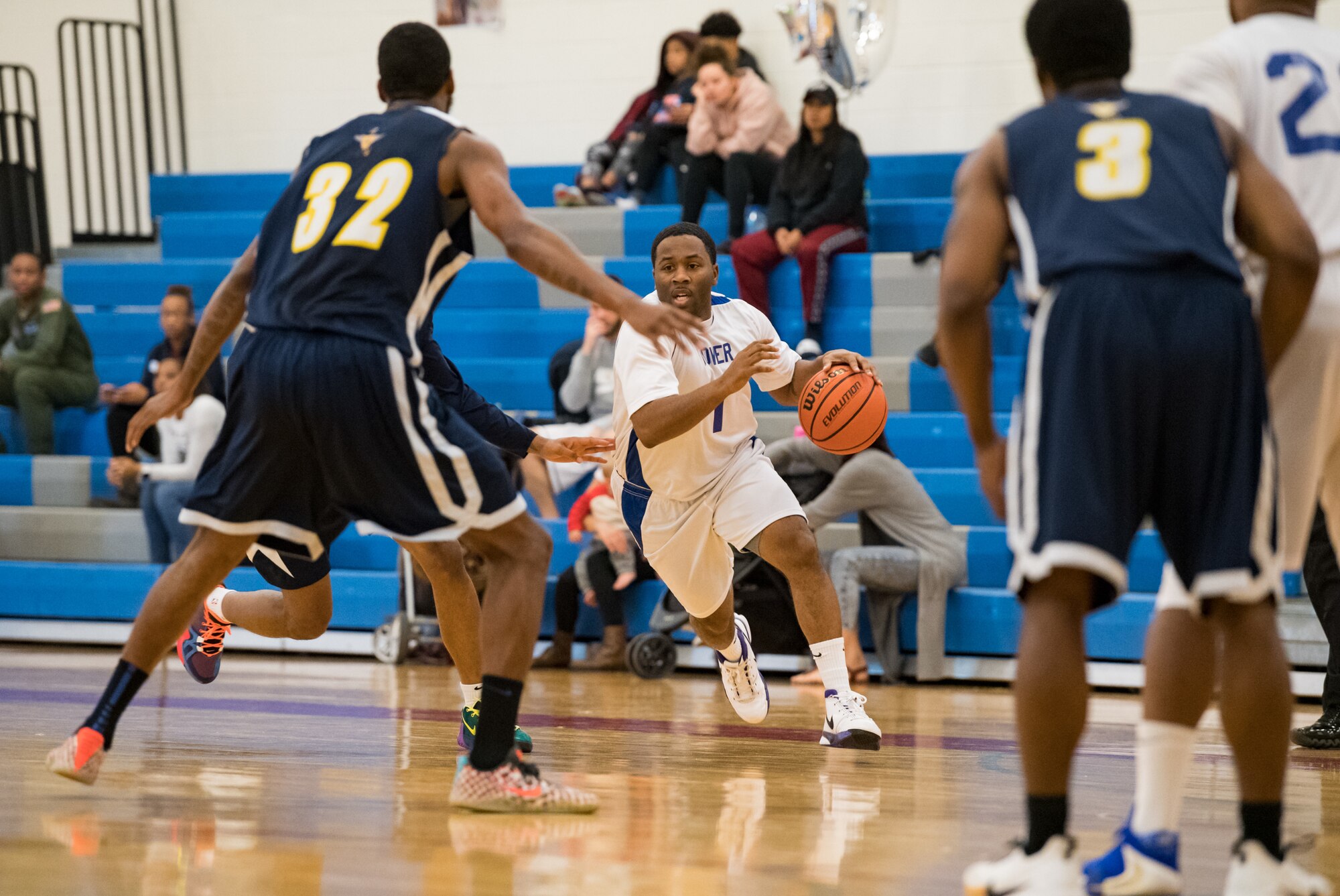 Dover Air Force Base Eagles guard Javarus Turner (1) drives toward Naval Support Activity Bethesda Warriors center Charles Lewis (32) Jan. 12, 2020, at the Fitness Center on Dover AFB, Del. The Warriors topped the Eagles, 88-70, in a Washington Area Military Athletic Conference basketball game. (U.S. Air Force photo by Roland Balik)