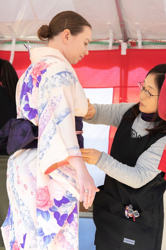 A member of Team Yokota gets dressed in a Kimono during the New Year Fest hosted by the Japanese Welfare Association, Jan.10, 2020, at Yokota Air Base, Japan