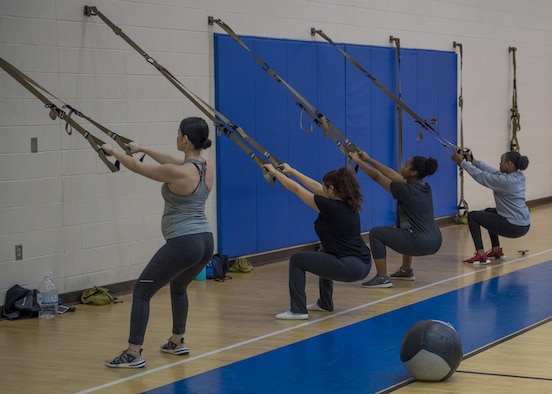 Participants in the prenatal fitness class perform TRX squats at Joint Base Langley-Eustis, Virginia, Jan. 13, 2020.