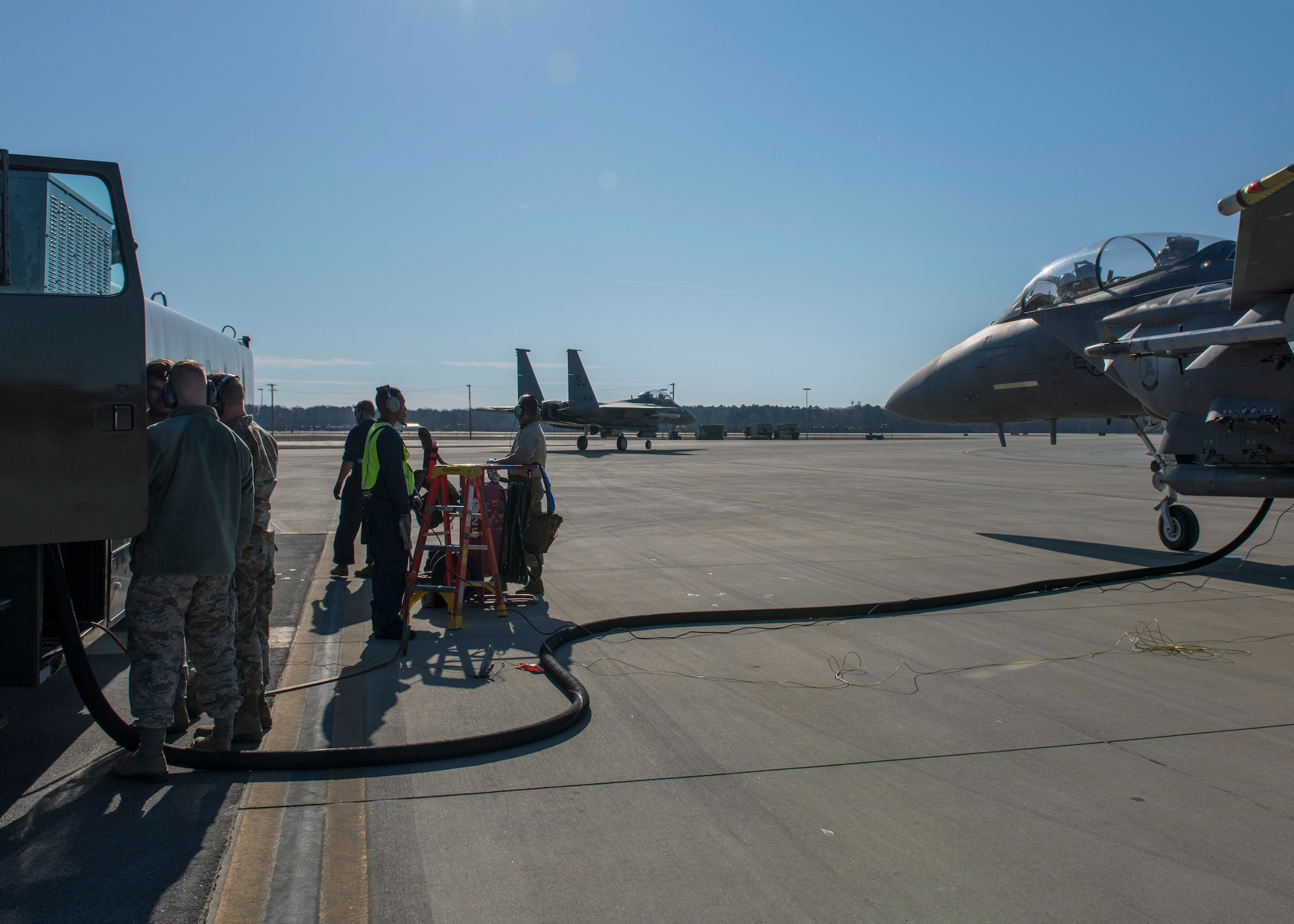 Airmen from the 4th Logistics Readiness Squadron execute a hot-pit refueling on an F-15E Strike Eagle.