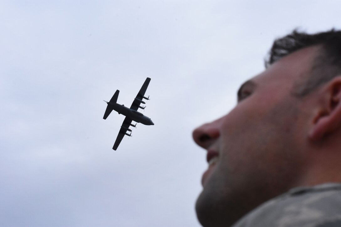 U.S. Air Force Capt. Patrick Mills watches the return of one of the 908th Airlift Wing's C-130 Hercules. The planes temporarily relocated earlier last week as part of the weather evacuation plan. (U.S. Air Force photo by Senior Airman Max Goldberg)