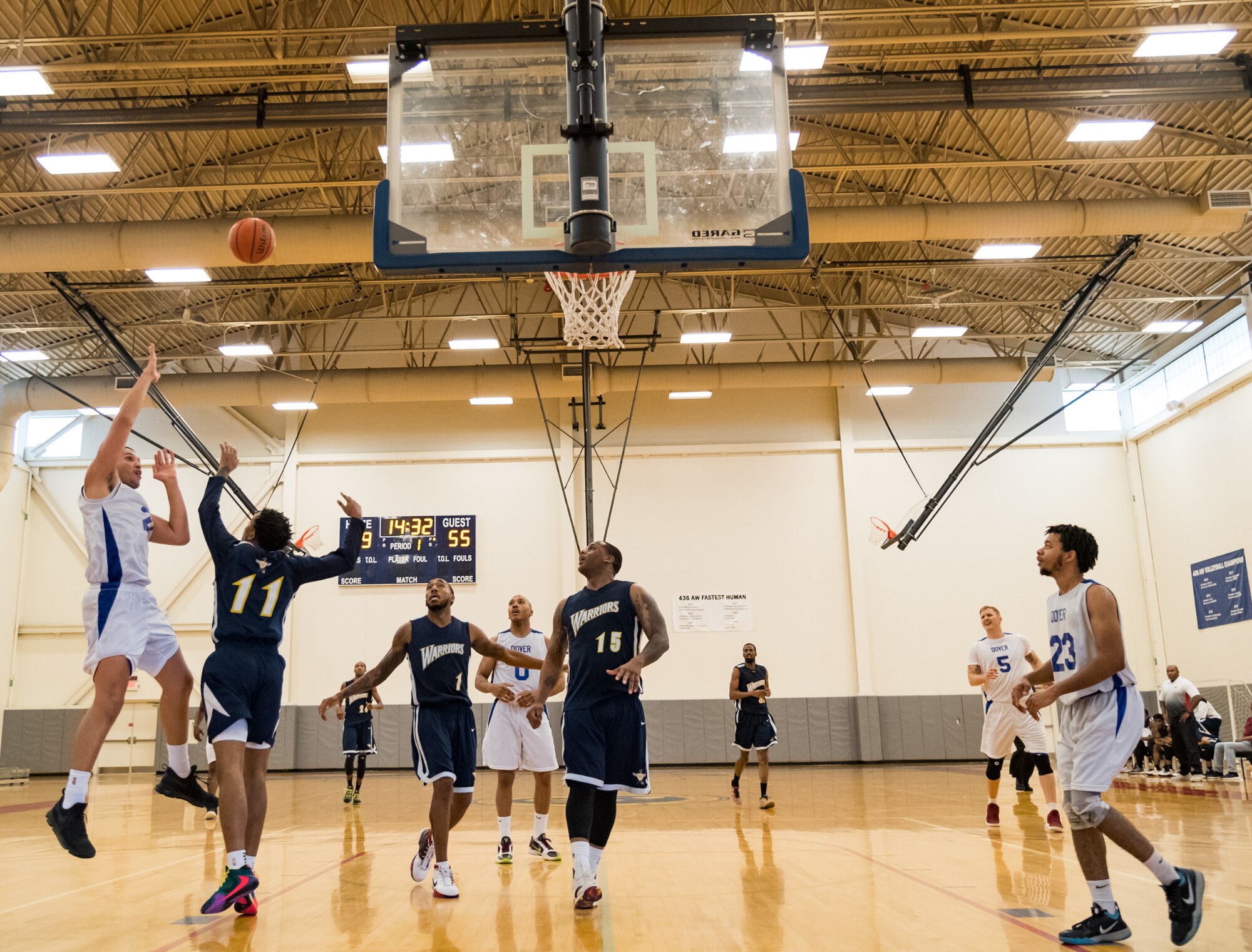 Dover Air Force Base Eagles center Miguel Garcia shoots over Naval Support Activity Bethesda Warriors guard William Gilmore (11) during the second half of their Washington Area Military Athletic Conference basketball game Jan. 12, 2020, at the Fitness Center on Dover AFB, Del. The Warriors, ranked number three in the WAMAC, topped the Eagles, 88-70. (U.S. Air Force photo by Roland Balik)