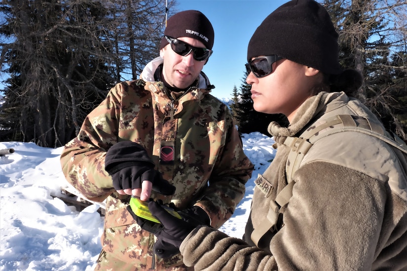 U.S. Army Reserve Sgt. Lara R. Dasilva, a supply sergeant with the 2500th Digital Liaison Detachment, 7th Mission Support Command, and Caporal Maggiore Capo Thomas De Toni, an Italian Army instructor with the Ski and Climbing Platoon, 79th Company, 6th Alpine Regiment, use a Pieps avalanche beacon to locate a notional avalanche victim for winter survival training during exercise Alpine Rock in Toblach, Italy, January 11, 2020. Fifteen Soldiers from the 2500th participated in the winter survival training that emphasized small-unit tactical interoperability.