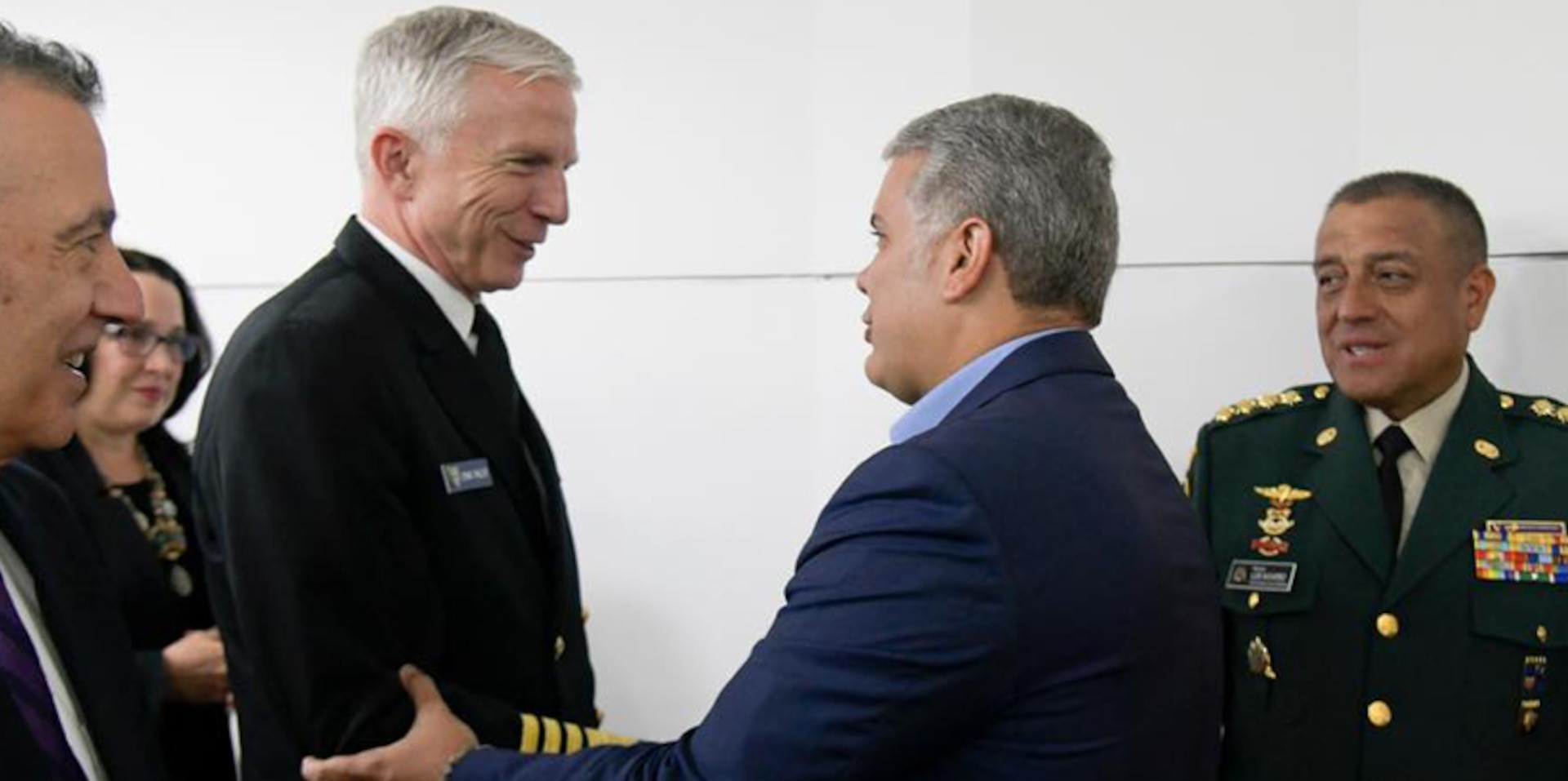 Colombian President Ivan Duque greets Adm. Craig S. Faller.