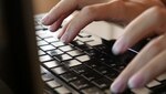 Hands typing on computer keyboard