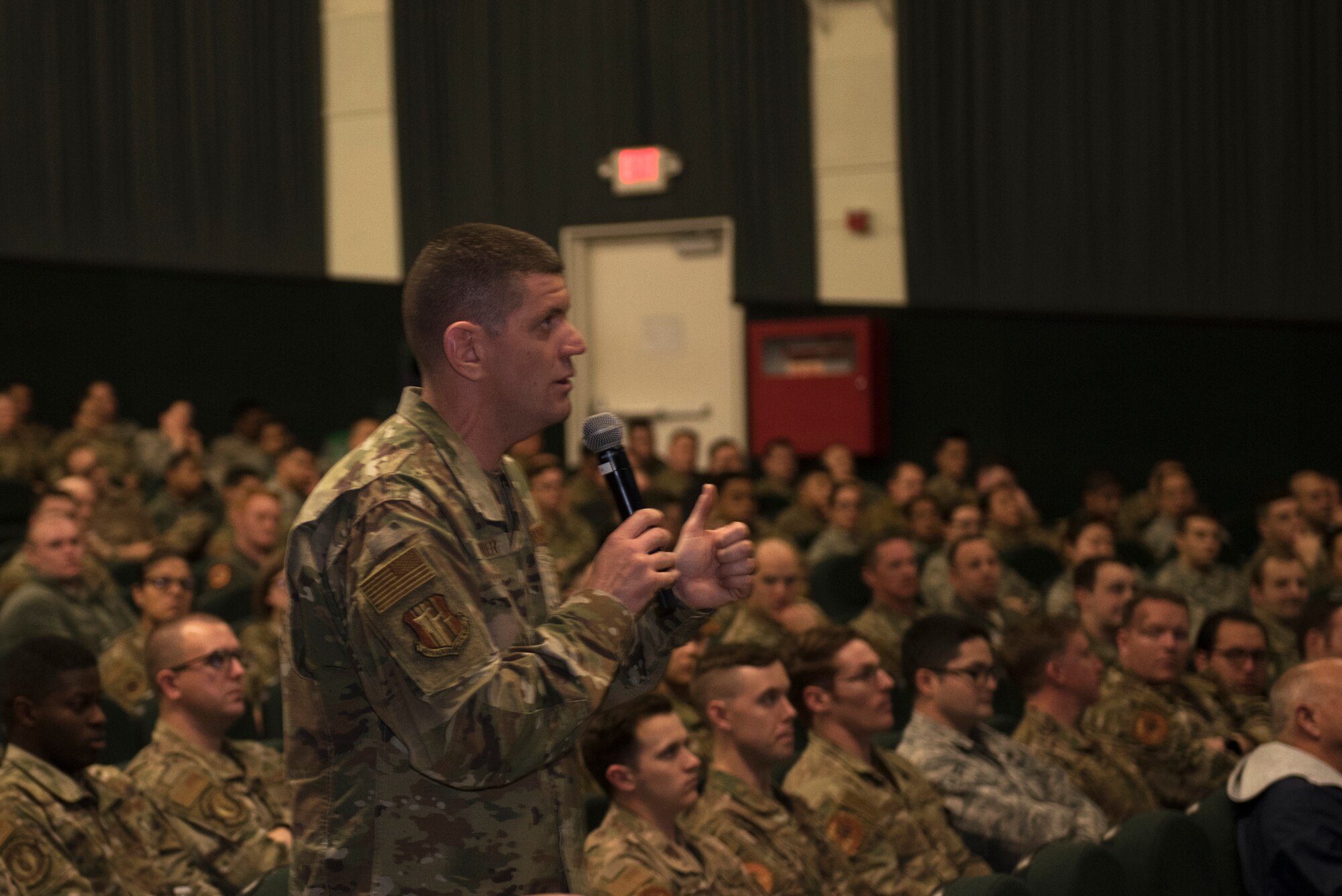 U.S. Air Force Chief Master Sgt. Derek Crowder, 60th Air Mobility Wing command chief, speaks to Airmen during a commander’s call Jan. 7, 2020, at Travis Air Force Base, California. Col. Jeff Nelson, 60th AMW commander, and Crowder spoke to Airmen about Club Hub, Airmen Against Drunk Driving and other topics. (U.S. Air Force photo by Airman 1st Class Cameron Otte)