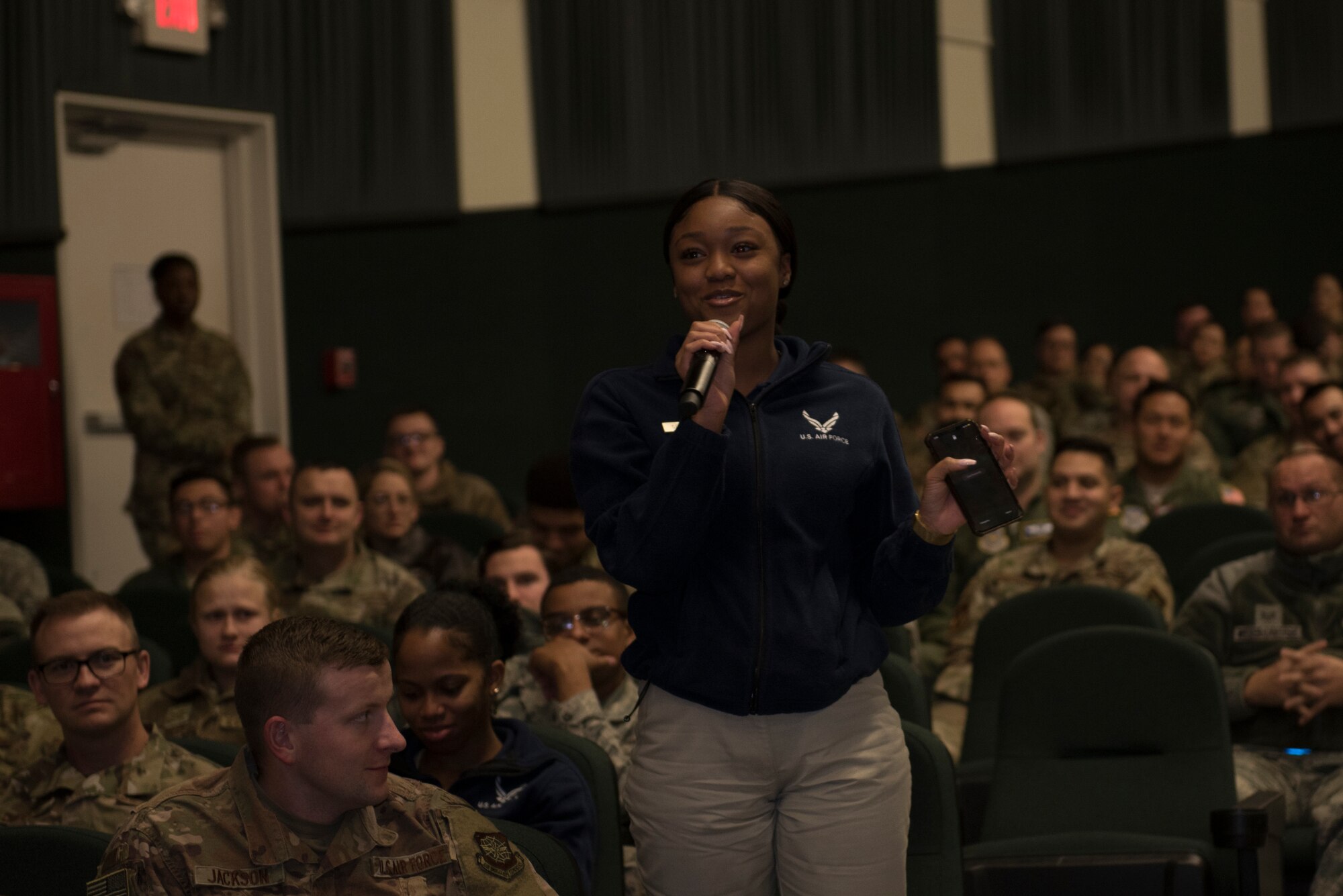 U.S. Air Force Senior Airman Jakeya Ellebb, 60th Force Support Squadron special events coordinator, asks a question during a commander’s call Jan. 7, 2020, at Travis Air Force Base, California. Col. Jeff Nelson, 60th Air Mobility Wing commander, and Chief Master Sgt. Derek Crowder, 60th AMW command chief, spoke to Airmen about Club Hub, Airmen Against Drunk Driving and other topics. (U.S. Air Force photo by Airman 1st Class Cameron Otte)
