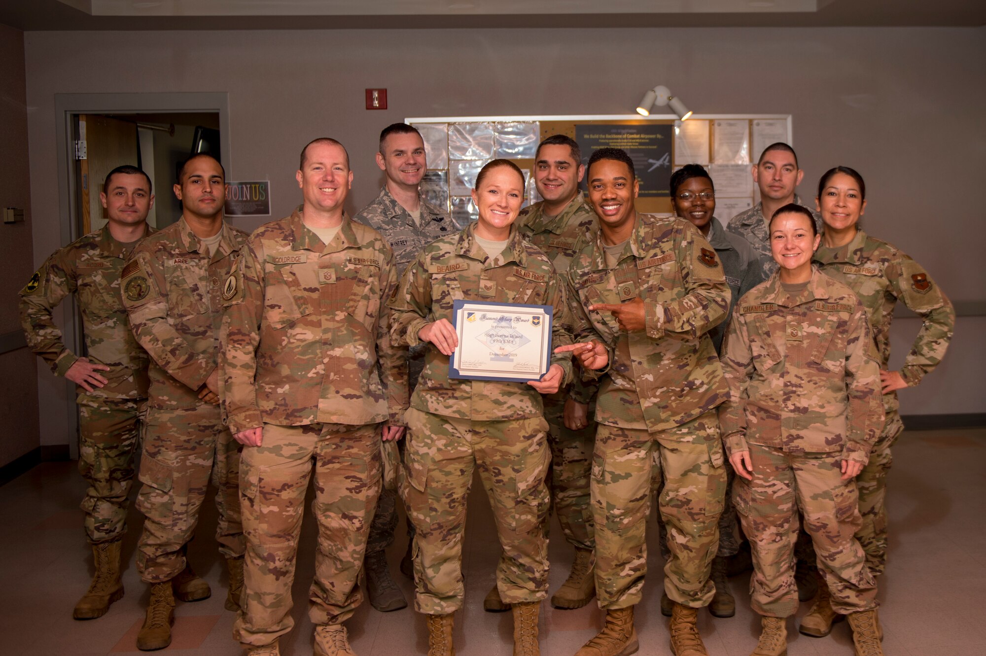 Staff Sgt. Serena Beaird, 49ths EMS unit deployment manager, receives the Diamond Sharp Award from the 49th Wing First Sergeants Council, Jan. 14, 2020. Every month, a first sergeant has the honor of choosing a deserving Airman to be presented the Diamond Sharp Award for an outstanding act or continuous outstanding performance. (U.S. Air Force photo by Airman 1st Class Kristin Weathersby)
