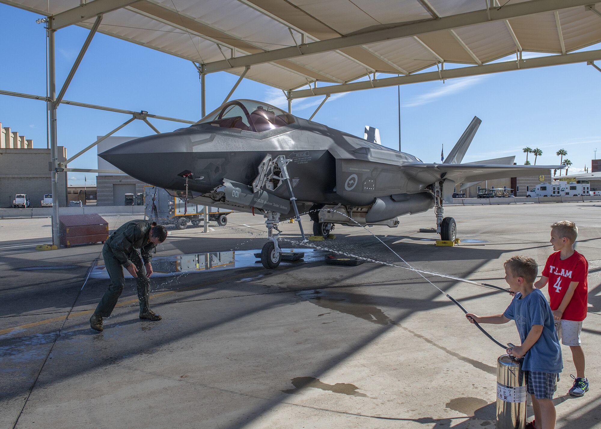 Lt. Col. Jordon Sander, 61st Fighter Squadron Australian Senior National Representative and new commander of the Royal Australian Air Force No. 2 Operational Conversion Unit (No. 2 OCU), is sprayed with water following his final flight at Luke Air Force Base Nov. 22, 2019, at Luke Air Force Base, Ariz.