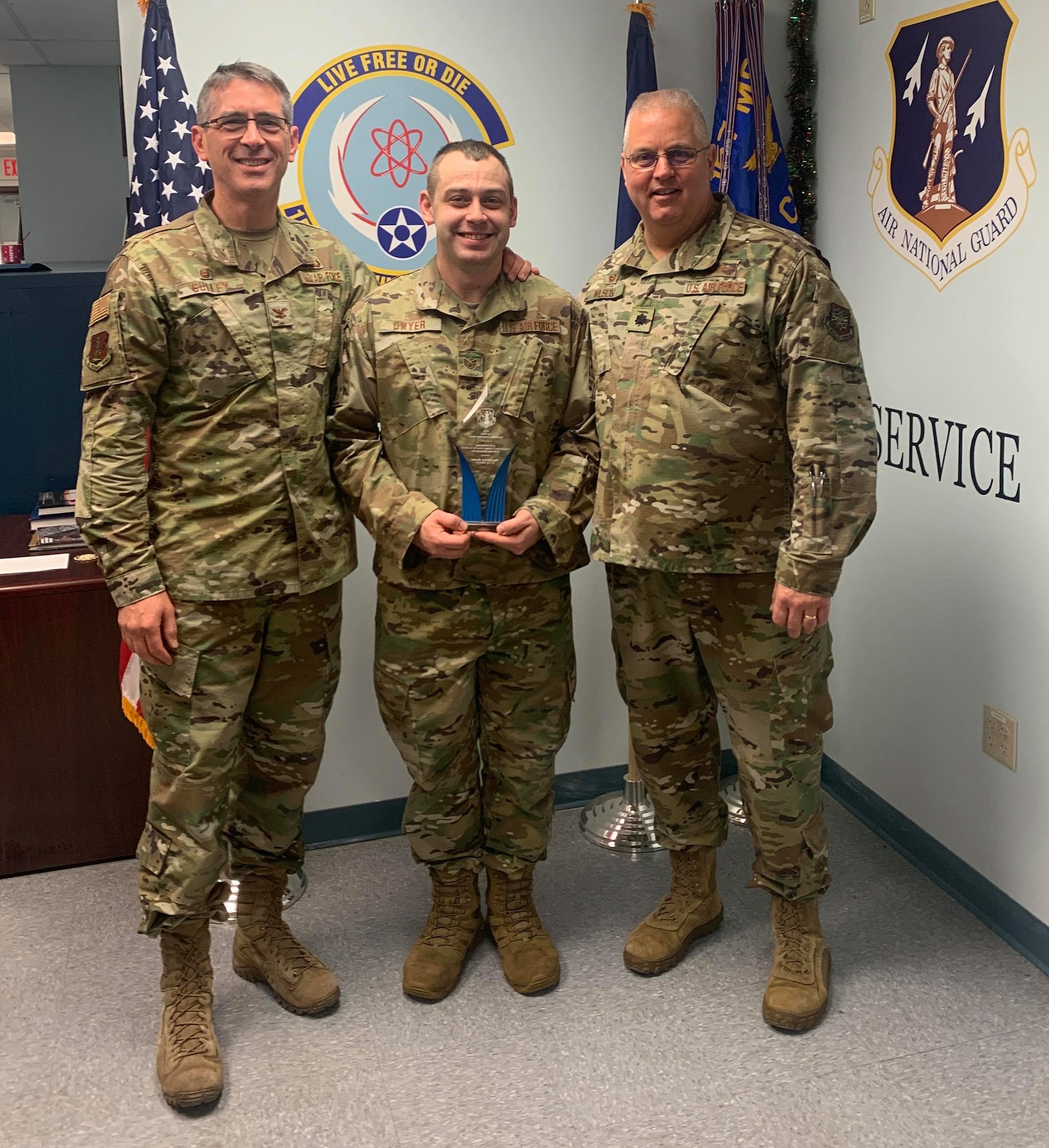 Col. Stryder Sulley, Staff Sgt. Alan Dwyer and Lt. Col William Wilson, Pease Air National Guard Base, N.H. on Dec. 7, 2019. Sulley presented Dwyer with the 2019 Gen. John P. Jumper Award for Excellence in Warfighting Integration and Information Dominance during the 157th Communications' unit training assemply roll call. The award recognizes the best and brightest Airmen, teams, and units for their sustained superior performance in providing information dominance and cyberspace superiority to Air Force and (or) DoD missions and operations.(Photo courtesy 157th Communications Flight)