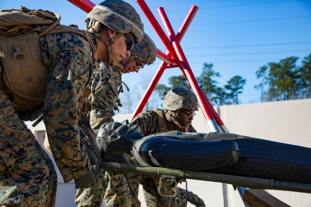 U.S. Marines work together on an obstacle at the Leadership Reaction Course on Marine Corps Base Camp Lejeune, North Carolina, Jan. 7.