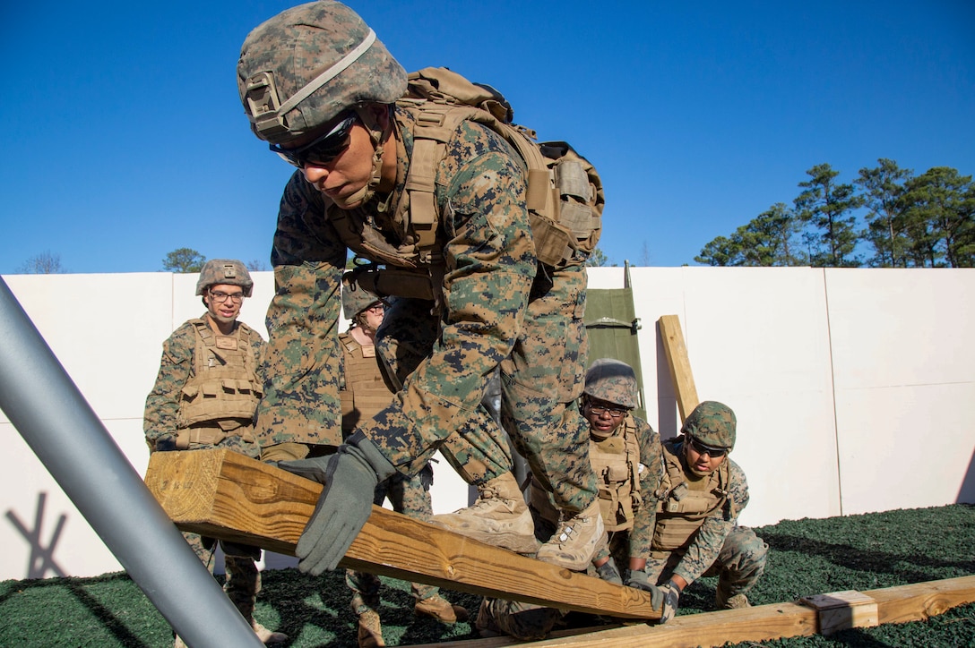 U.S. Marines with 2nd Assault Amphibian Battalion, 2nd Marine Division, work together on an obstacle at the new Leadership Reaction Course (LRC) on Marine Corps Base Camp Lejeune, North Carolina, Jan. 7, 2020.