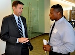 IMAGE: KING GEORGE, Va. – Naval Surface Warfare Center Dahlgren Division (NSWCDD) Deputy for Small Business Kris Parker speaks with II Corps Consultants, Inc., executive Earnest King at an NSWCDD event for small businesses. A Small Business Administration final rule to implement the 2018 Small Business Runway Extension Act effective on Jan. 6, 2020 is good news for Dahlgren, according to Parker. The law increased the period of measuring small businesses’ annual revenue from three to five years in the contract evaluation process. “This change to five years is a logical move, as it helps account for the cyclical nature of contract awards,” he said. “It should really help increase our potential small business base.”  (U.S. Navy photo/Released)