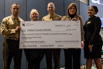 Leaders from MCAS New River and the Lejeune-New River School Liaison Officers pose for a photo after the National Math and Science Initiative Grant Award Ceremony at the Regional Skills Center on Dec. 11, 2019.