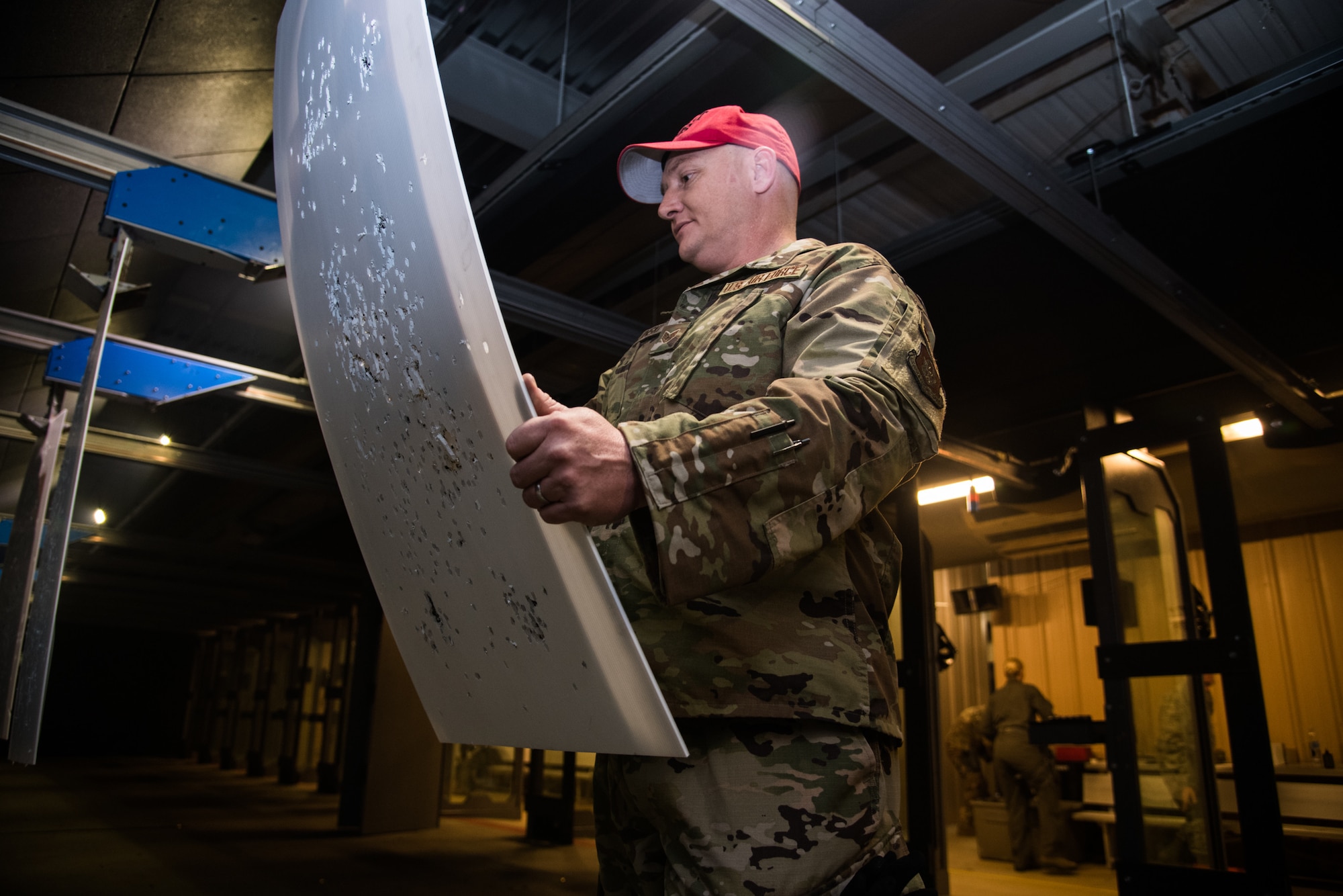 Staff Sgt. Jacob Ceglinski, 932nd Security Forces combat arms instructor evaluates the target during an M9 Air Force Qualification Course, , Jan. 11, 2020, Scott Air Force Base, Illinois. Citizen Airmen with the 932nd AW learned the components of the M9 pistol, sights, cleaning and care, and how to properly fire the weapon. (U.S. Air Force photo by Senior Airman Brooke Deiters)