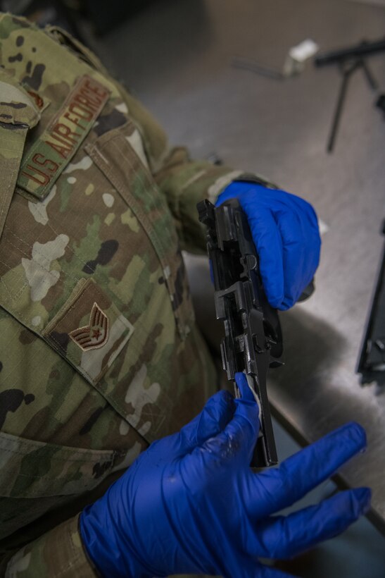Citizen Airmen with the 932nd Airlift Wing clean weapons after participating in M-9 pistol qualification, Jan. 11, 2020, Scott Air Force Base, Illinois. Combat arms instructors provide classroom lessons and hands-on training to refresh Airmen’s weapon knowledge. The course sharpens their weapon systems skills and ensures optimal performance of the firearms they carry daily. (U.S. Air Force photo by Senior Airman Brooke Deiters)