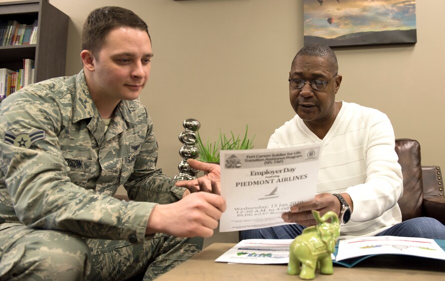 SCHRIEVER AIR FORCE BASE, Colo. – Airman Gabe Garrison, 50th Operations Support Squadron student, talks with Mel Castile, Schriever Airman and Family Readiness Center personal, work-life and employment specialist, about federal job resources for his spouse Jan. 15, 2020. Staff from the Schriever AFRC and other base helping agencies will provide a variety of resources on current Air Force and DOD support programs during an information fair scheduled 11 a.m.-1 p.m. Jan. 21 outside the base dining facility. (U.S. Air Force photo by Heather S. Marsh)