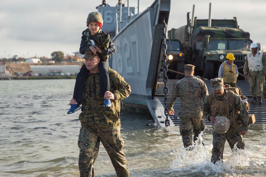 U.S. Marines with the Combat Logistics Battalion 11 (CLB-11), 11th Marine Expeditionary Unit, disembark onto the beach during their homecoming at Camp Pendleton, California, Nov. 26, 2019. The 11th MEU is returning home after being deployed aboard the Boxer Amphibious Ready Group, having completed operations and exercises in the U.S. Indo-Pacific Command and U.S. Central Command areas of responsibility. (U.S. Marine Corps photo by Pfc. Seth G. Merz)