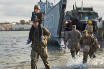 U.S. Marines with the Combat Logistics Battalion 11 (CLB-11), 11th Marine Expeditionary Unit, disembark onto the beach during their homecoming at Camp Pendleton, California, Nov. 26, 2019.