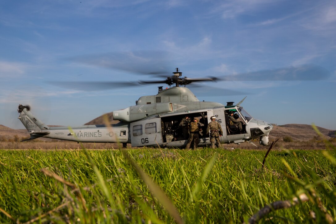 U.S. Marines climb into a UH-1Y Venom with Marine Light Attack Squadron 469 during a helicopter rope suspension technician (HRST) masters course at Marine Corps Base Camp Pendleton, California, Dec. 11, 2019. The course provided the students the ability to conduct HRST techniques safely on their own, including special purpose insertion/extraction (SPIE) rigging, fast roping, and rappelling from helicopters, enabling their units to be able to insert and extract anywhere, even when a landing zone is unavailable. (U.S. Marine Corps photo by Lance Cpl. Brendan Mullin)