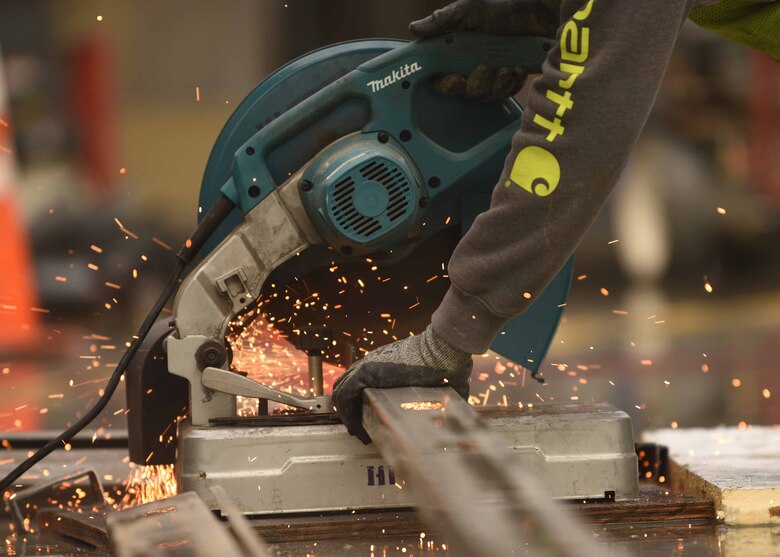 Tyler Weber, Hi Tec Interior construction worker, cuts metal to install posts at the new combat arms training and maintenance range Jan. 14, 2020, at McConnell Air Force Base, Kansas. The project is expected to use approximately 500 contracted workers to build and finalize the new CATM range. (U.S. Air Force photo by Airman 1st Class Alexi Bosarge)