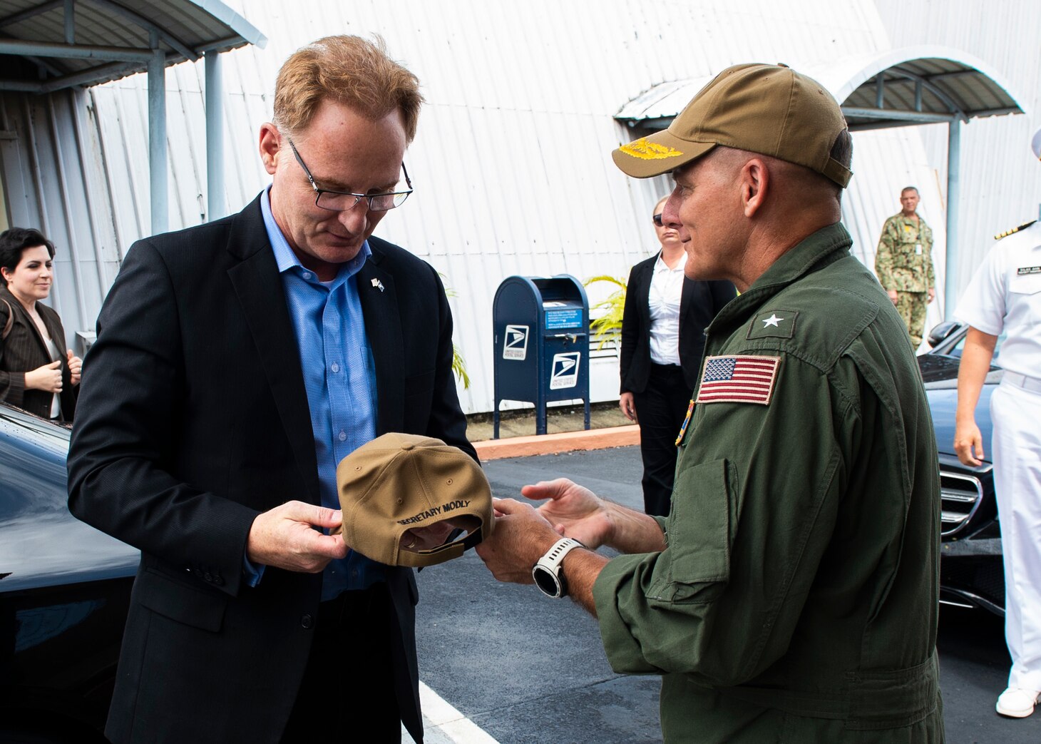 SINGAPORE (Jan. 15, 2019) Rear Adm. Joey Tynch, commander, Logistics Group Western Pacific, presents a command ballcap to the Honorable Thomas B. Modly, acting Secretary of the Navy, who is visiting Singapore. Secretary Modly’s visit to Singapore is part of a multi-nation visit to the U.S. Indo-Pacific areas of responsibility focused on reinforcing existing partnerships and visiting Sailors and Marines providing forward presence.