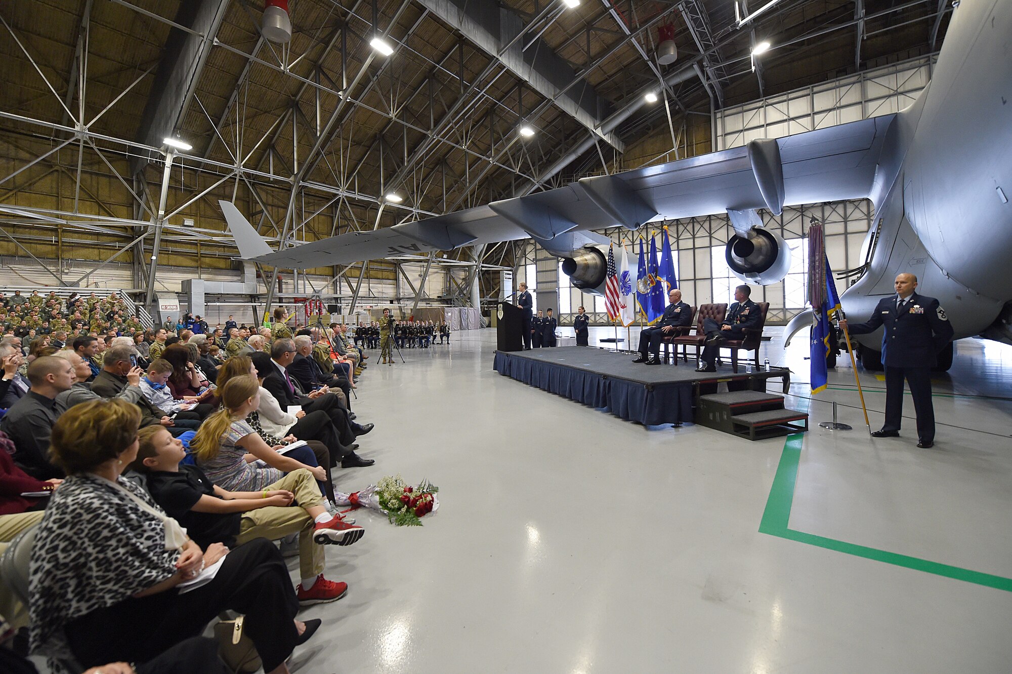 Col. Erin Staine-Pyne, 62nd Airlift Wing commander, center at the podium, address audience members for the first time as the wing commander, at the 62nd Airlift Wing change of command ceremony on Joint Base Lewis-McChord, Wash., Jan. 10, 2020.