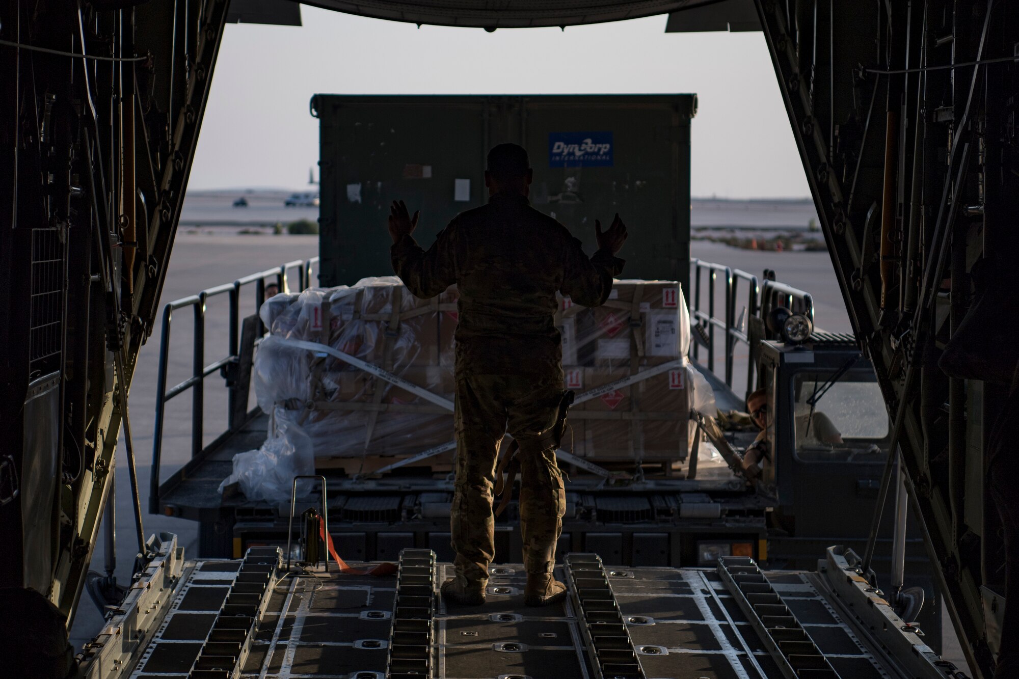 A U.S. Air Force loadmaster assigned to the 746th Expeditionary Airlift Squadron directs the loading of cargo into a C-130 Hercules in the U.S. Central Command area of responsibility, Jan. 8, 2020.
