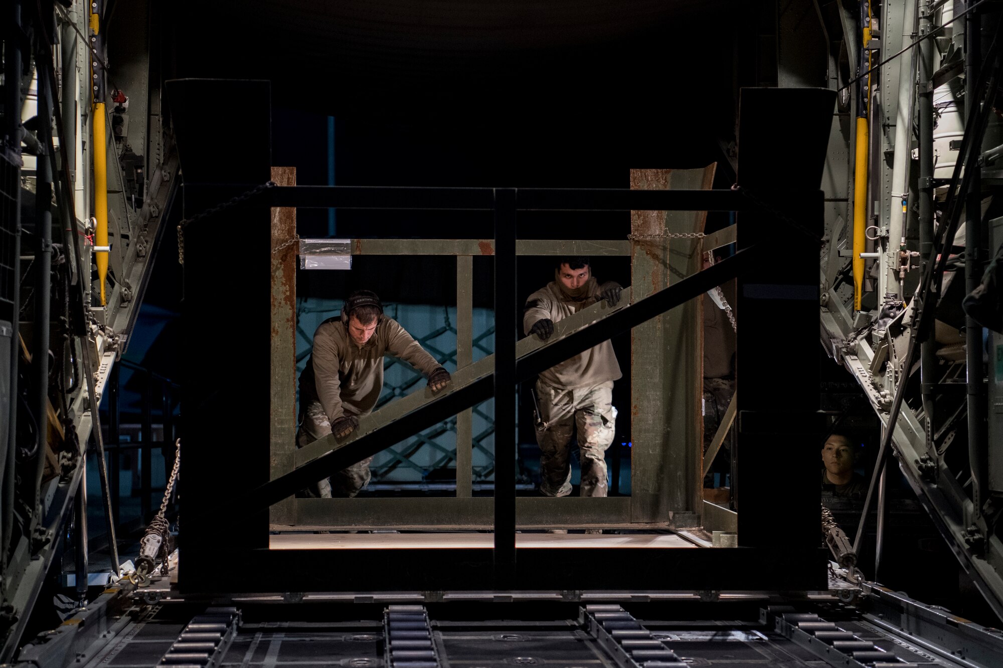 A U.S. Air Force aerial porters assigned to the Air Force Central Command load cargo into a C-130 Hercules with the 746th Expeditionary Airlift Squadron in the U.S. Central Command area of responsibility, Jan. 8, 2020.