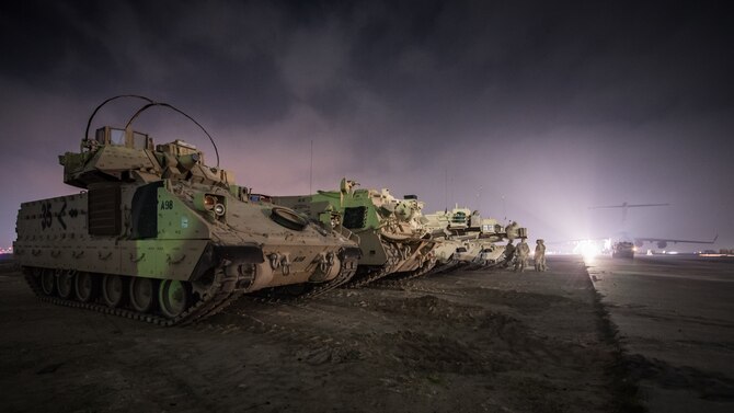 U.S. Army M1A1 Abrams tanks are parked next to a flight line in the U.S. Central Command area of responsibility, Jan. 3, 2020. USCENTCOM directs and enables military operations and activities with allies and partners to increase regional security and stability in support of enduring U.S. interests. (U.S. Air Force photo by Tech. Sgt. Daniel Martinez)