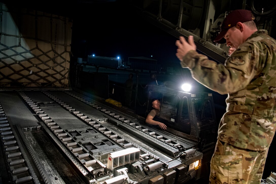 A U.S. Air Force loadmaster assigned to the 746th Expeditionary Airlift Squadron directs the loading of cargo into a C-130 Hercules within the U.S. Central Command area of responsibility, Jan. 8, 2020.