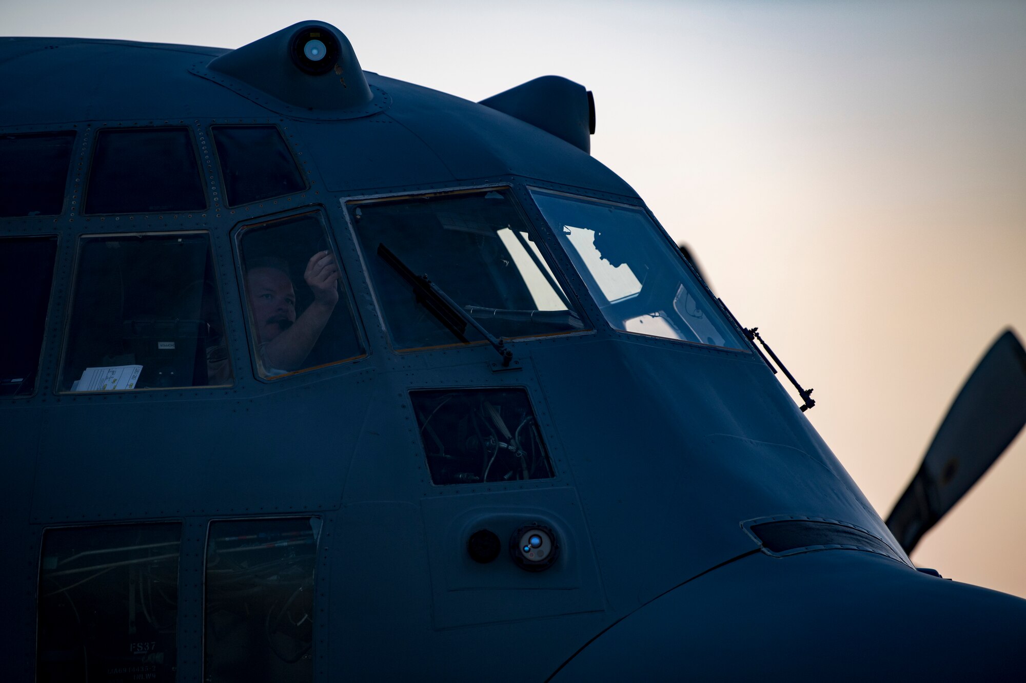 A U.S. Air Force pilot assigned to the 746th Expeditionary Airlift Squadron conducts preflight checks of a C-130 Hercules in the U.S. Central Command area of responsibility, Jan. 8, 2020.