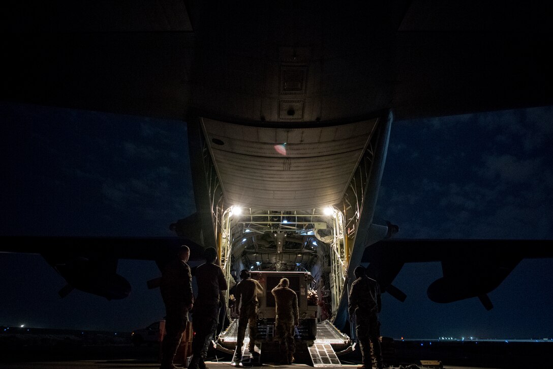 U.S. Air Force aerial porters assigned to U.S. Air Forces Central Command load cargo into a C-130 Hercules in the U.S. Central Command area of responsibility, Jan. 8, 2020.